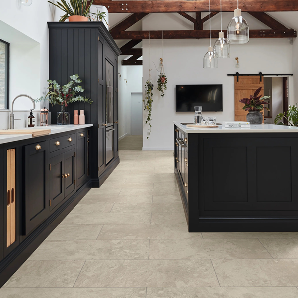 Kitchen with black cabinets and Karndean stone-look luxury vinyl tile flooring