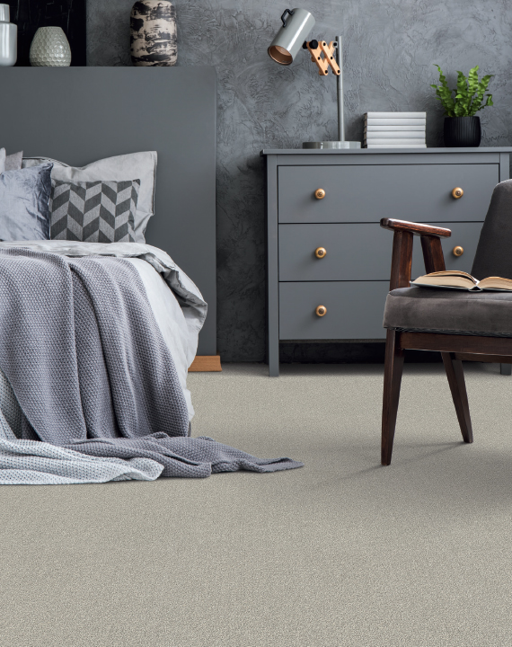 Close-up of clean, neutral-toned plush carpet sample