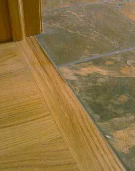 wood flooring next to tile flooring showing transition